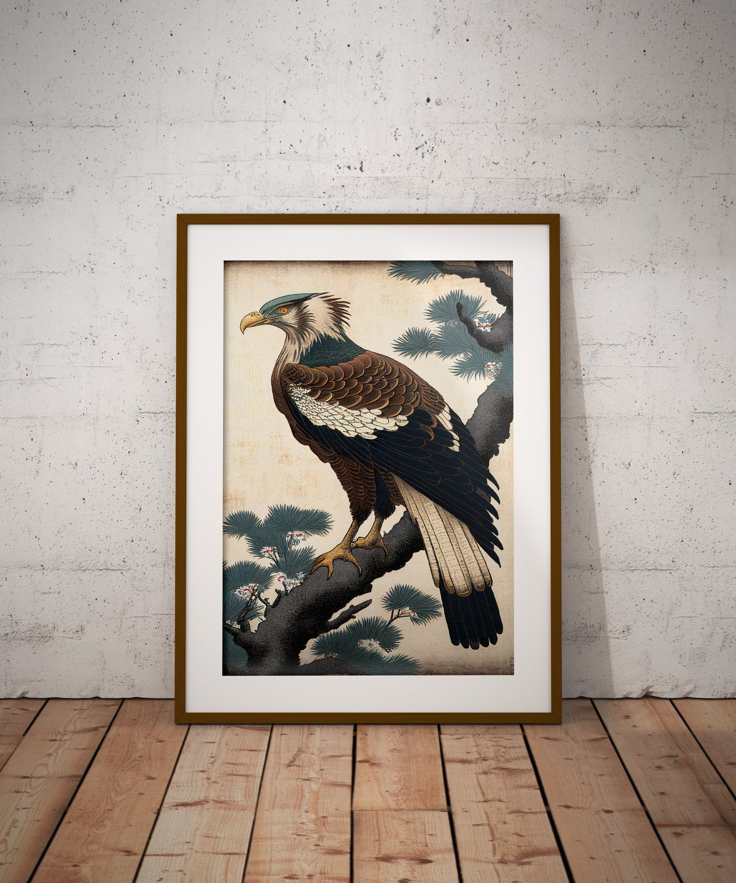 Poster aigle japonais, cadre bois foncé et passe-partout, posé au sol contre un mur de briques