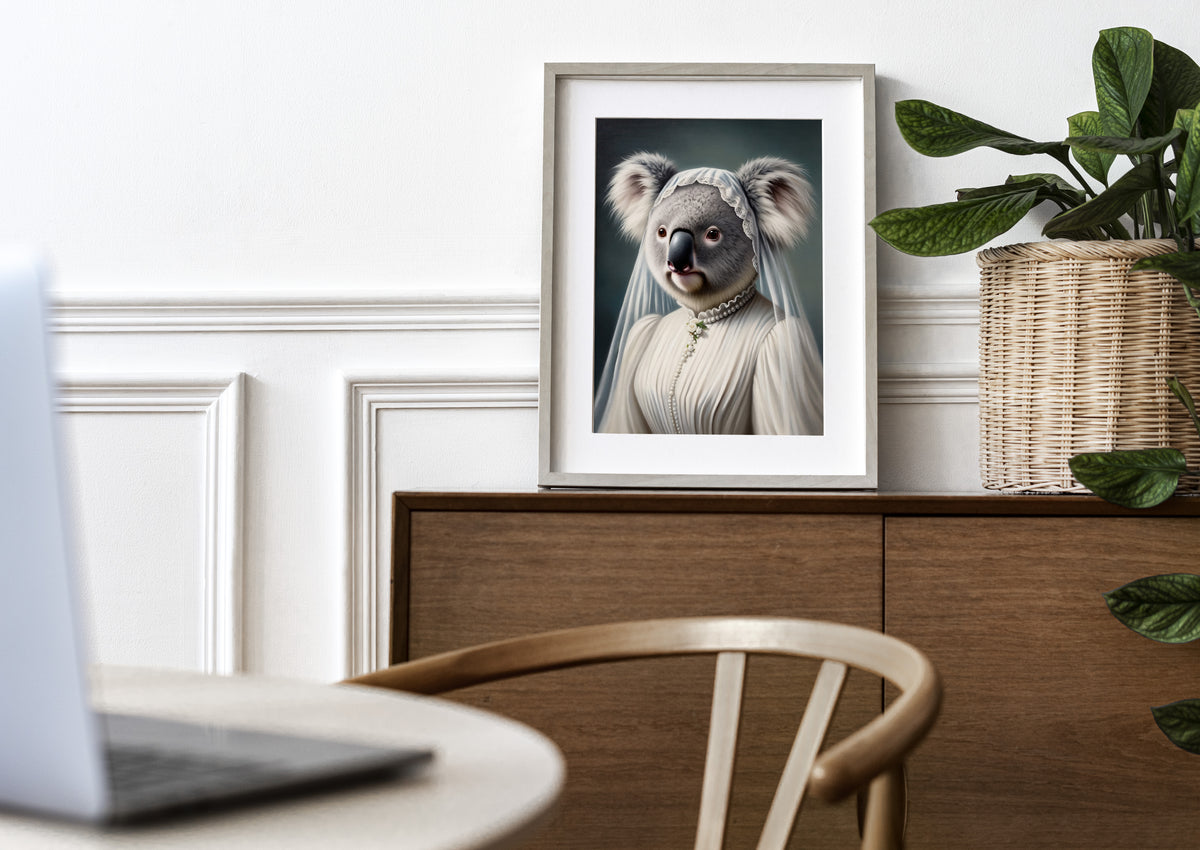 Koala bride poster in a natural wood frame with mat on a wooden sideboard near a plant