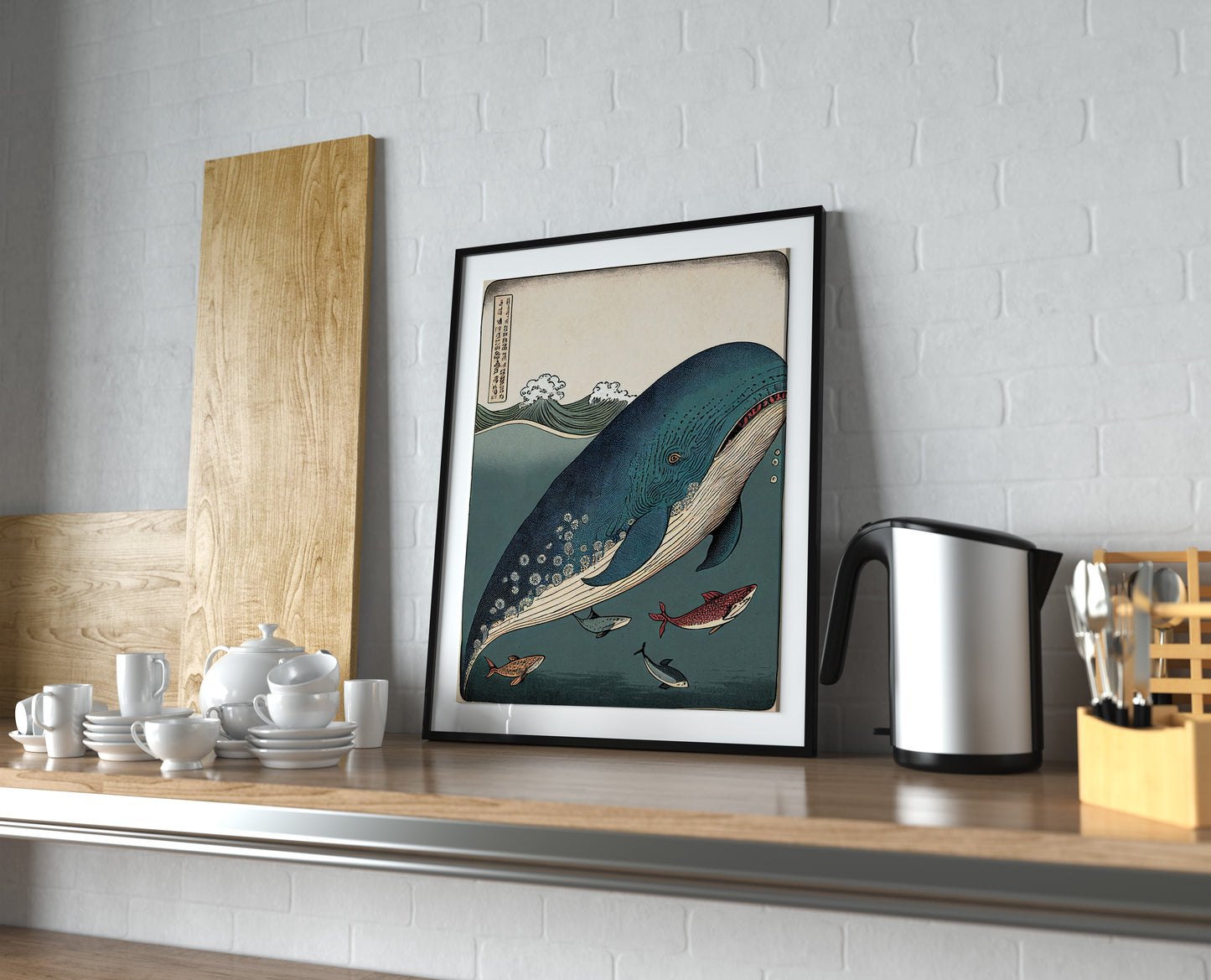 Whale and fish poster, black frame with white mat on a kitchen shelf next to a kettle