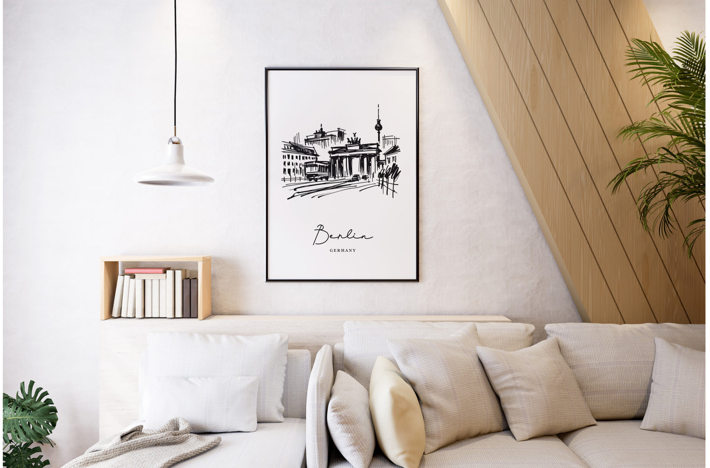 Black and white Berlin poster, black frame on a bright living room wall, white sofa and beige cushions