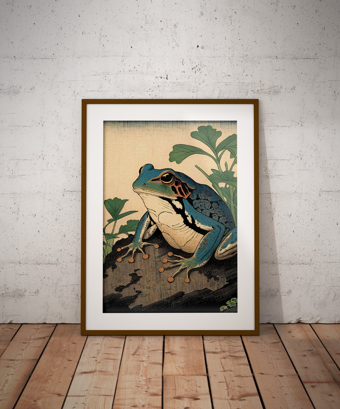 Poster grenouille art japonais, cadre bois foncé et passe-partout, posé au sol contre un mur de briques