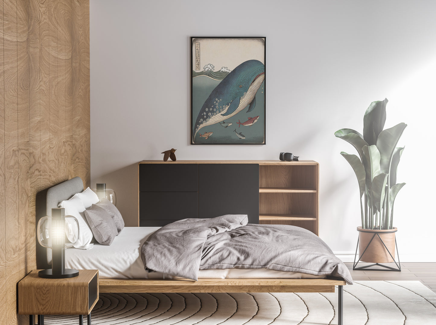 Ukiyo-e whale and fish poster hung above a bed with gray linens in a bright bedroom