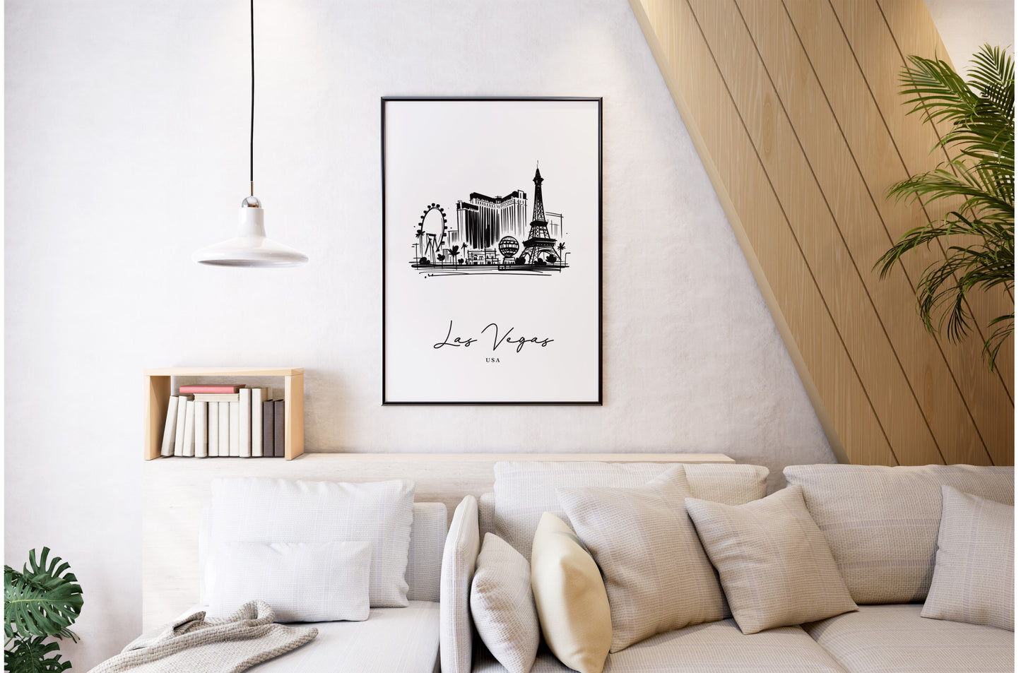 Poster des monuments de Las Vegas en cadre noir au-dessus d'un canapé blanc, salon clair avec suspension