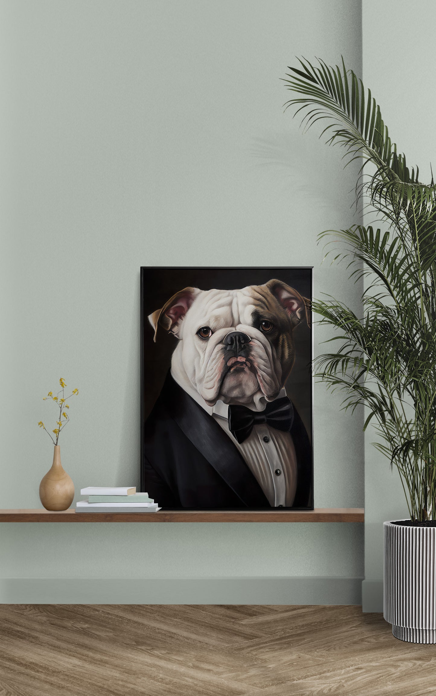 English bulldog in a tuxedo poster on a wall shelf against a sage green wall beside a potted palm