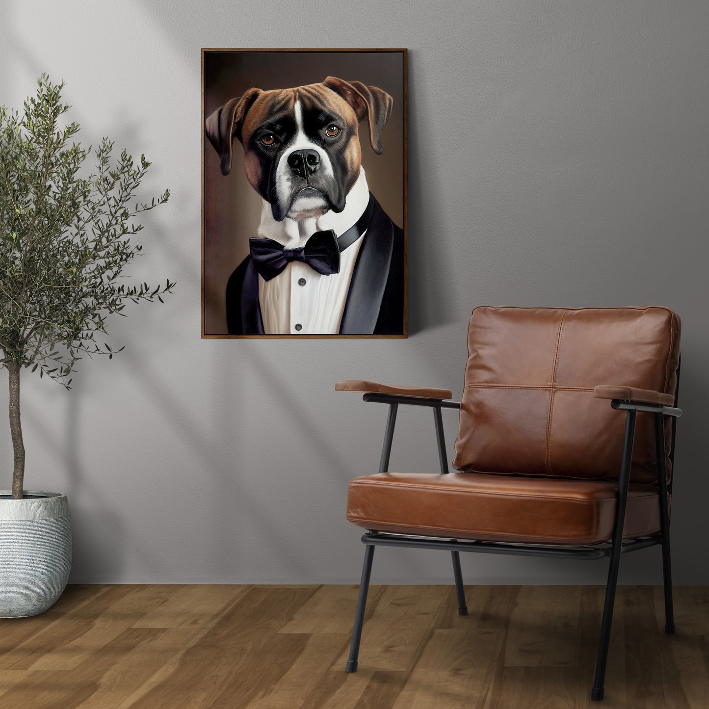 Boxer in tuxedo poster in a dark wood frame on a gray wall above a leather armchair