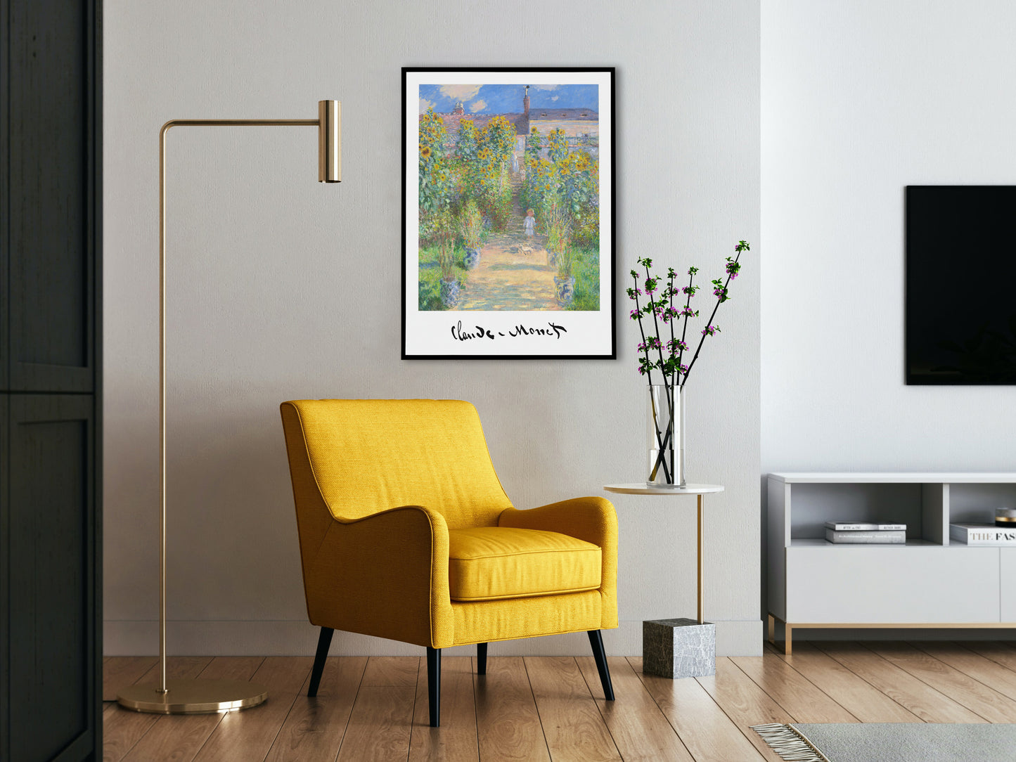Monet artist's garden poster in a black frame above a yellow armchair