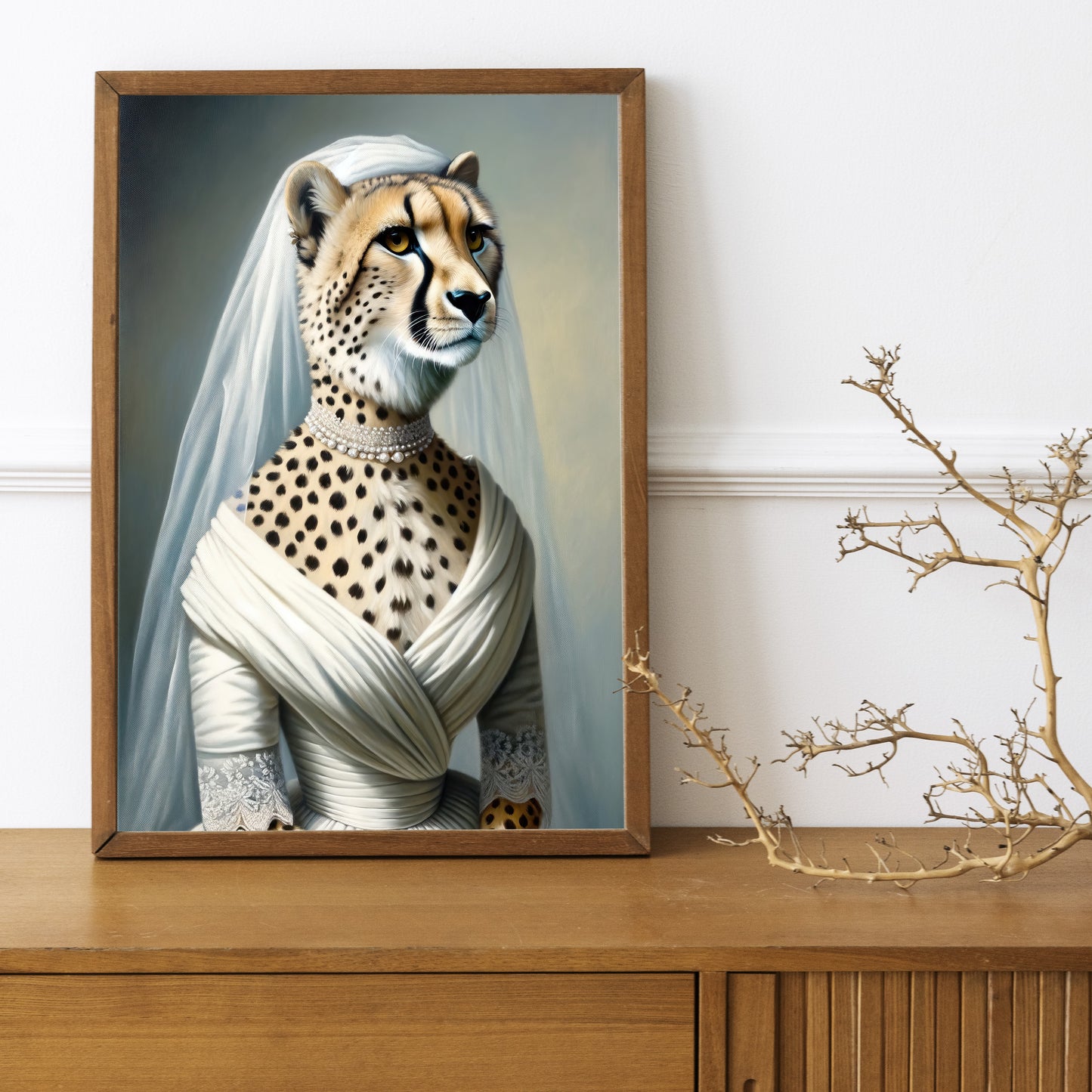 Cheetah in wedding dress poster in a dark wood frame on a wooden sideboard with a decorative branch