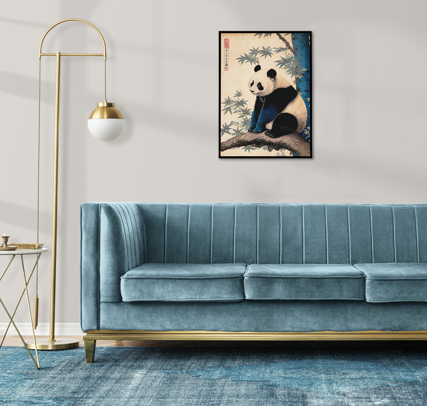 Japanese art panda poster in a black frame above a blue velvet sofa with a brass floor lamp
