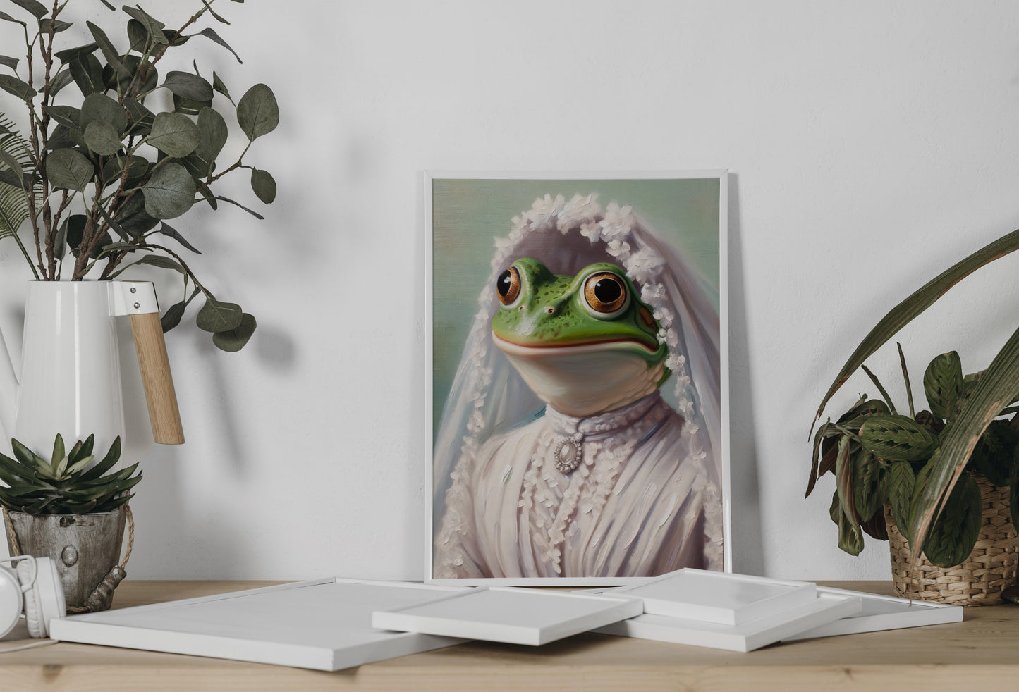 Frog in wedding dress poster leaning on a console between eucalyptus and a potted plant