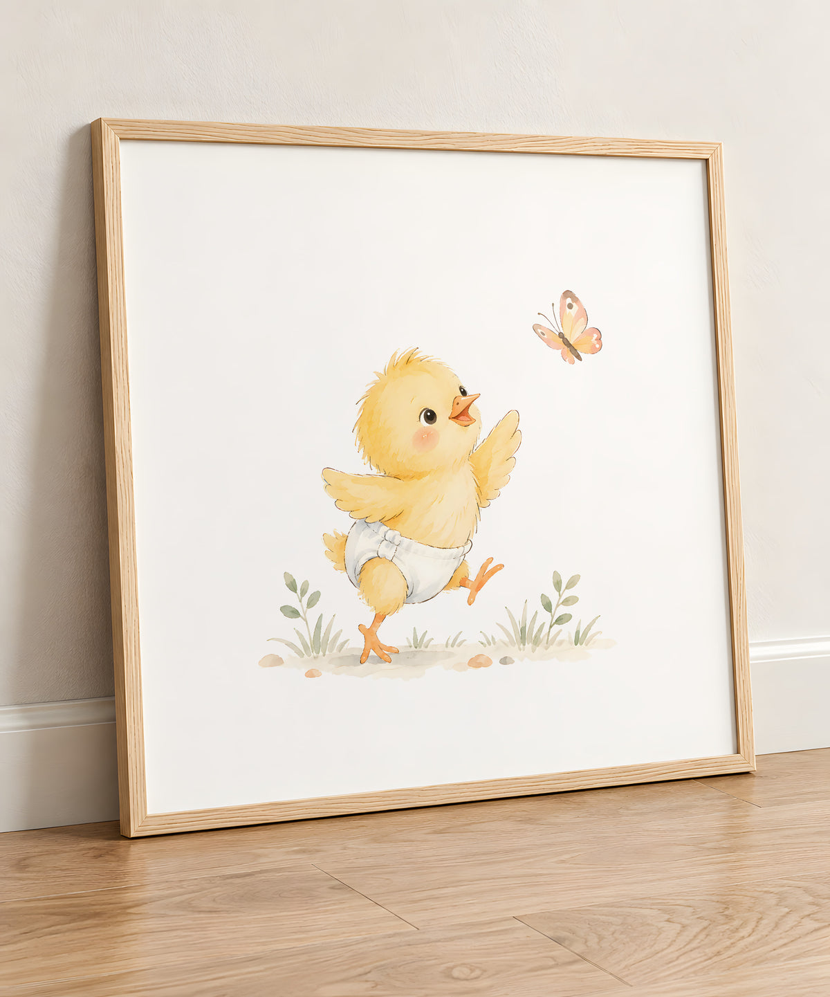Petit poussin en couche blanche poursuit un papillon dans l’herbe : cadre bois clair, 50 × 50 cm, en situation