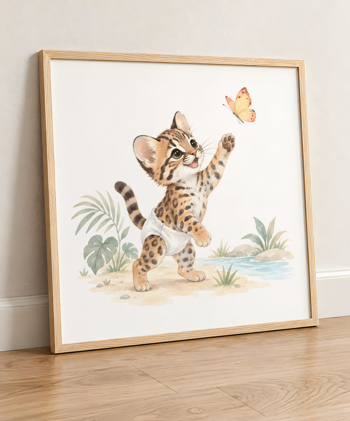 Baby Ocelot in a White Diaper Lifts a Paw to Catch a Butterfly: natural wood frame, 50 × 50 cm, styled in a room