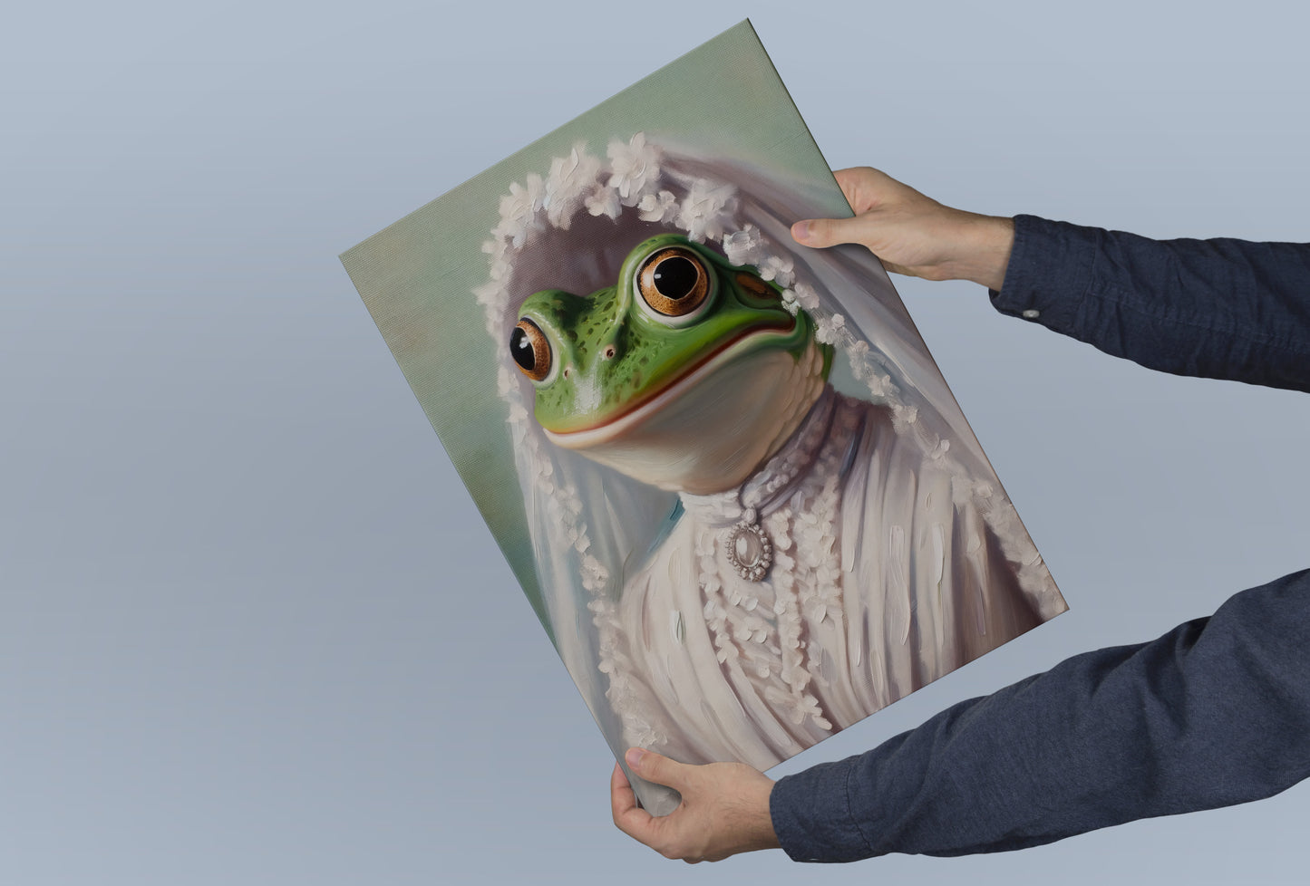 Frog bride poster held in both hands against a blue-gray background