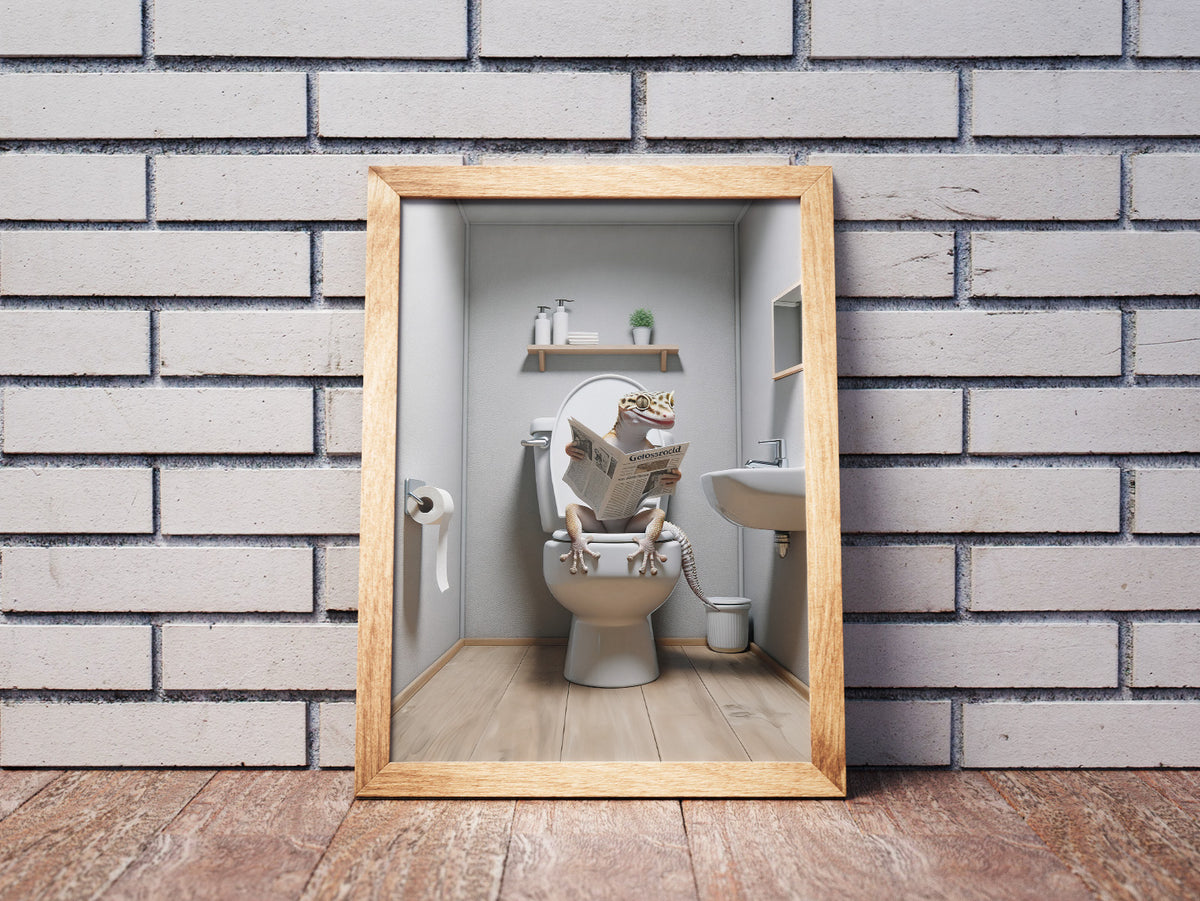 Poster lézard lisant le journal aux toilettes en cadre bois clair posé au sol devant un mur de briques blanches