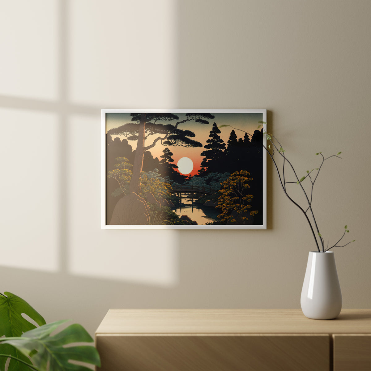 Poster jardin japonais en cadre blanc au-dessus d'une console bois clair, vase blanc et branches