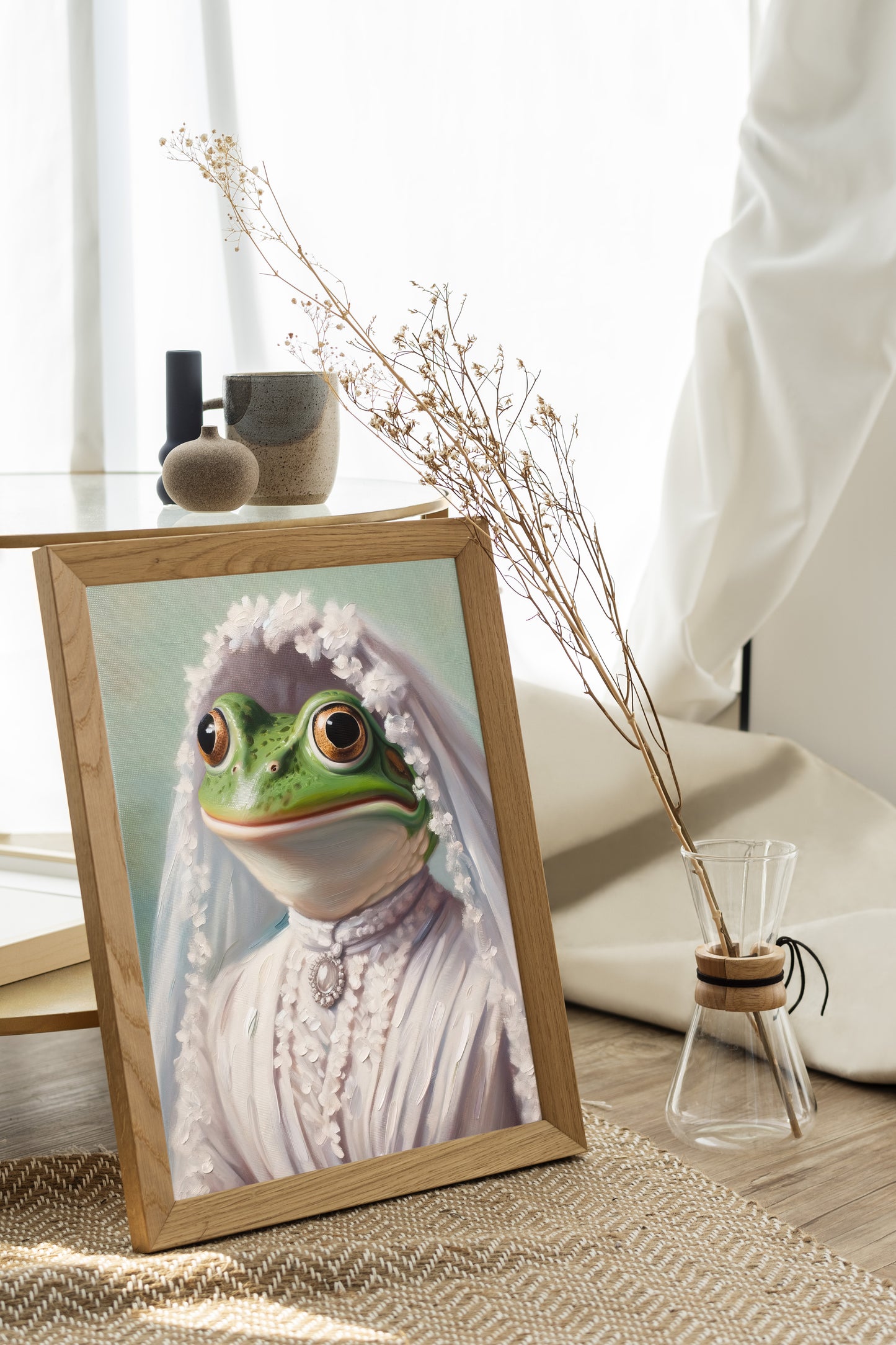 Frog bride poster in a natural wood frame on the floor by a window, dried flowers