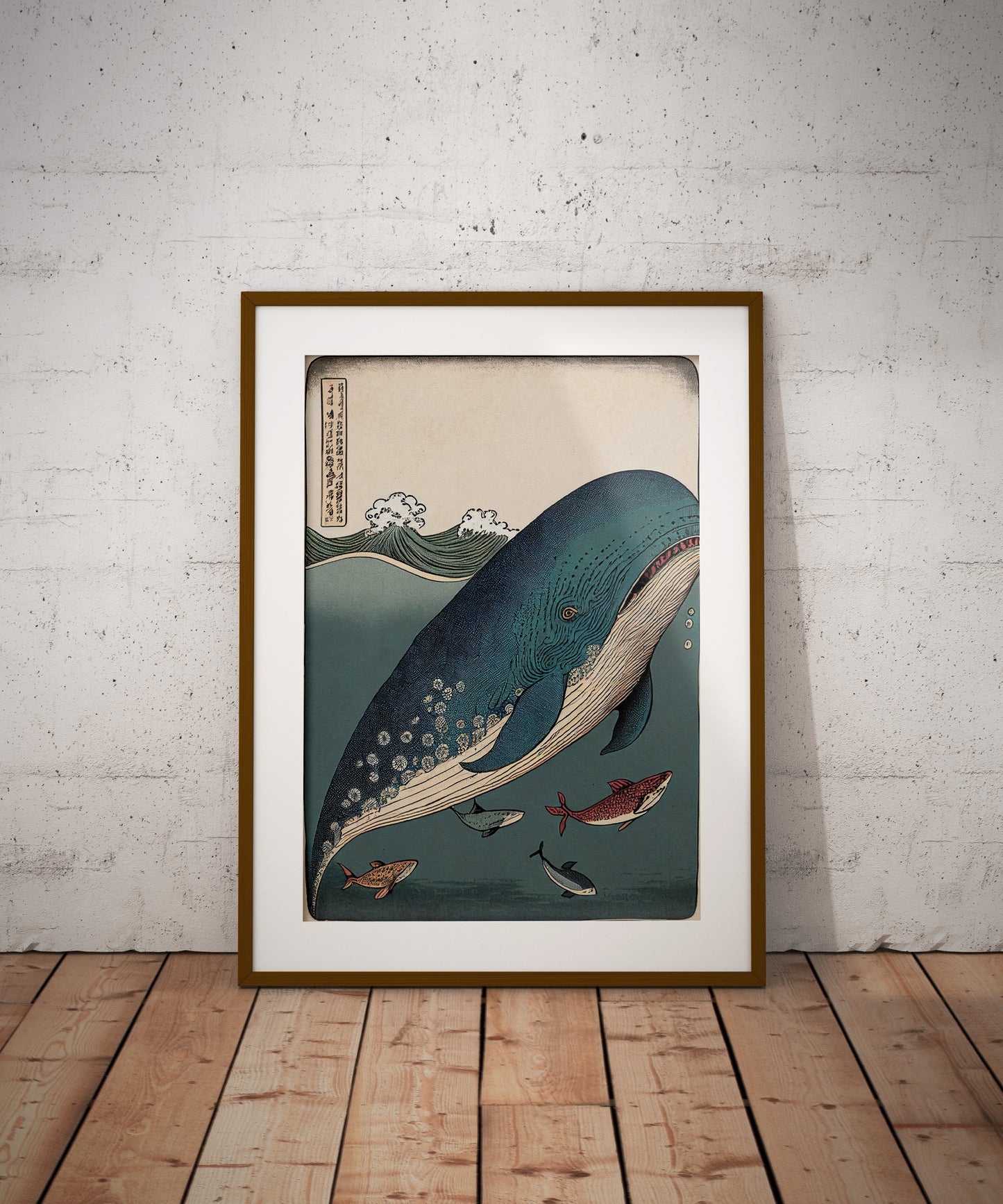 Whale and fish poster, dark wood frame with white mat, leaning on the floor against a brick wall