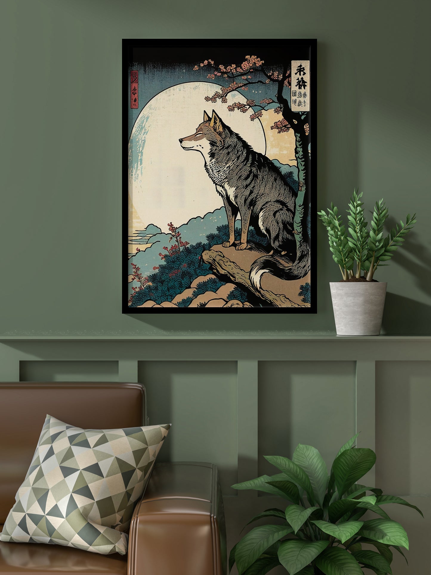 Poster loup style japonais, cadre noir, sur un mur vert olive au-dessus d'un canapé en cuir