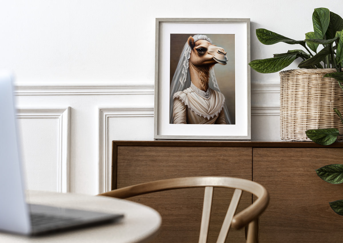 Camel in wedding dress poster in a natural wood frame with mat on a sideboard near a plant
