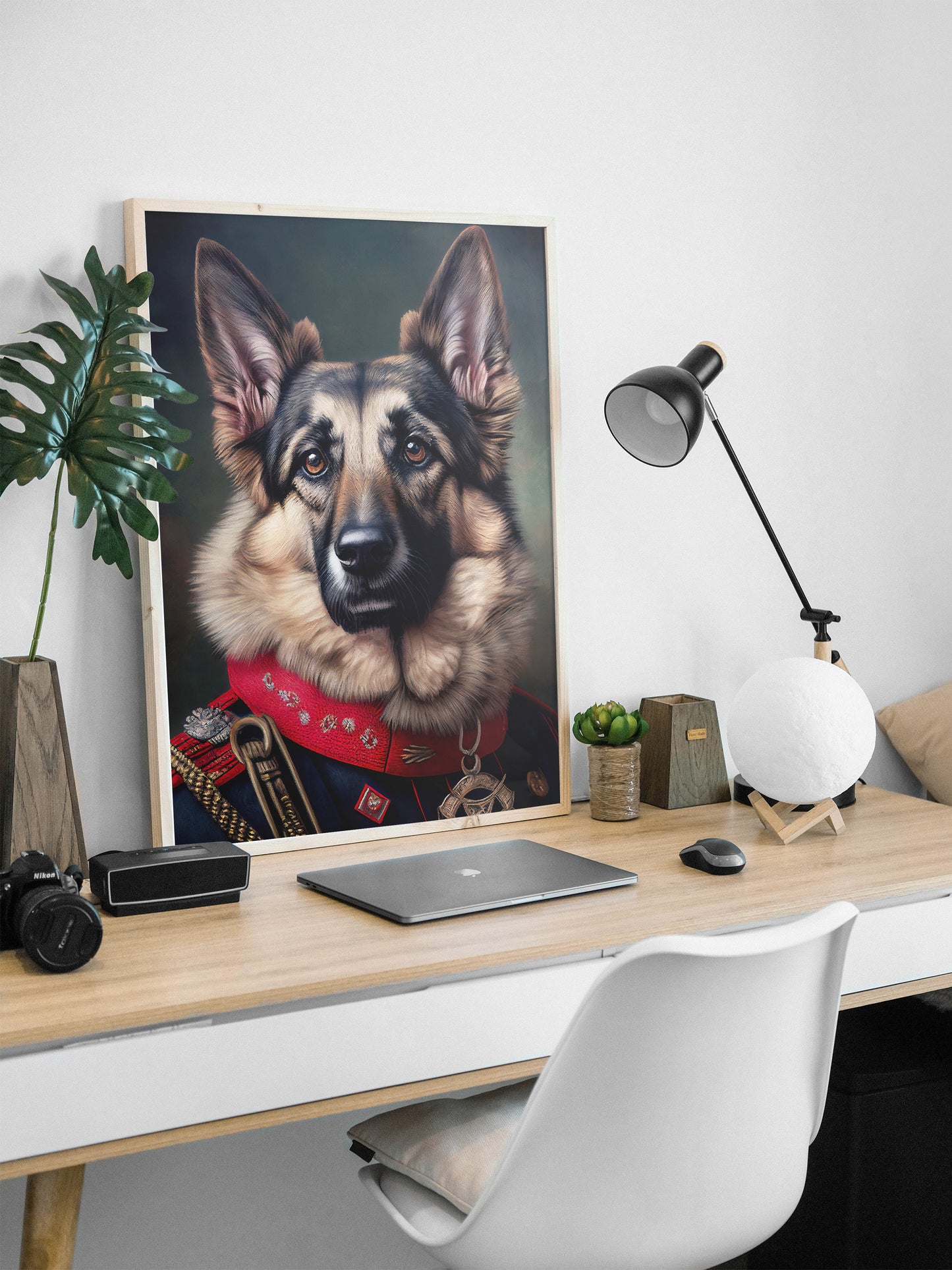 German Shepherd uniform poster in a natural wood frame leaning on a desk with a black lamp