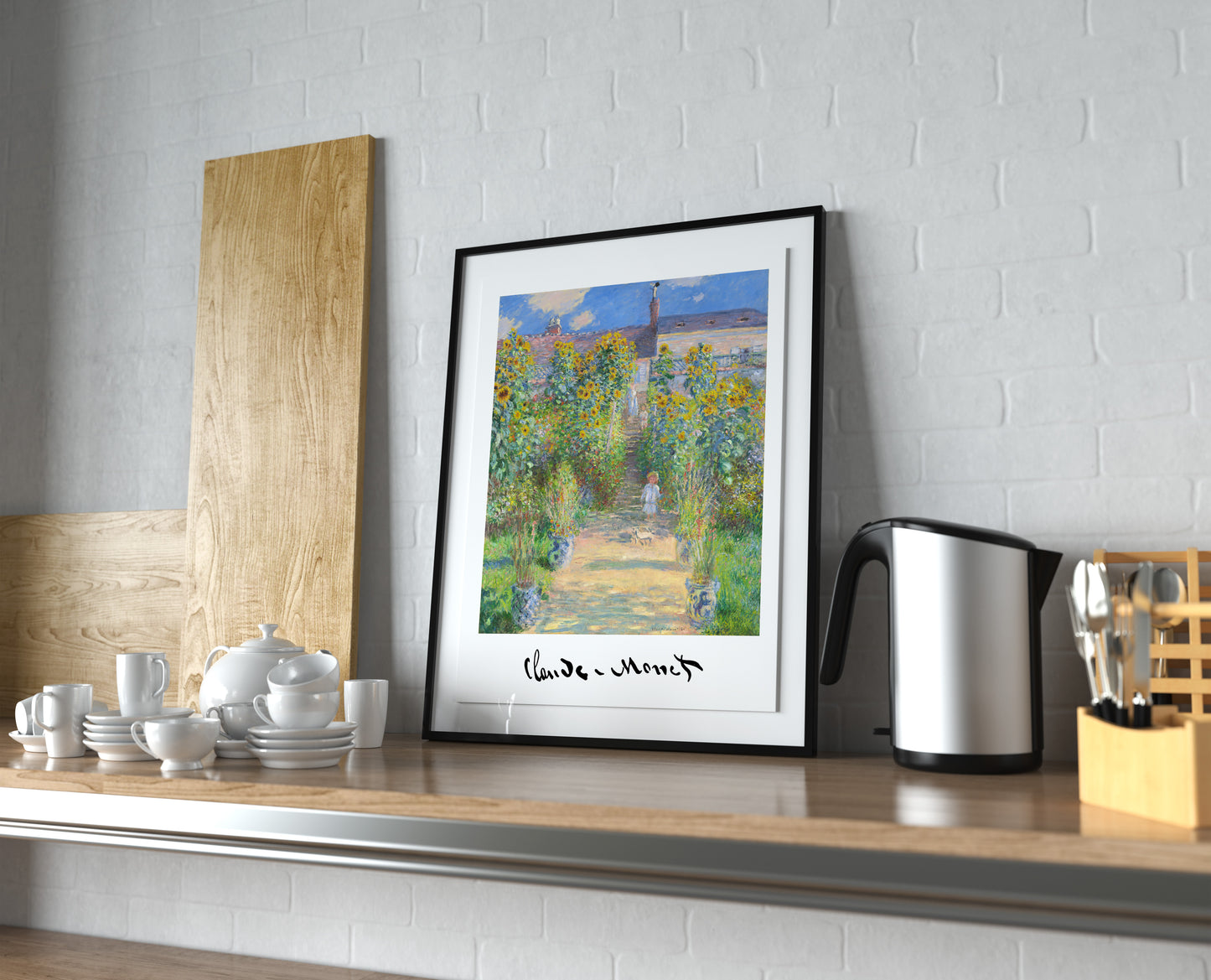 Monet garden at Vetheuil poster in a black frame with a mat, leaning on a kitchen counter