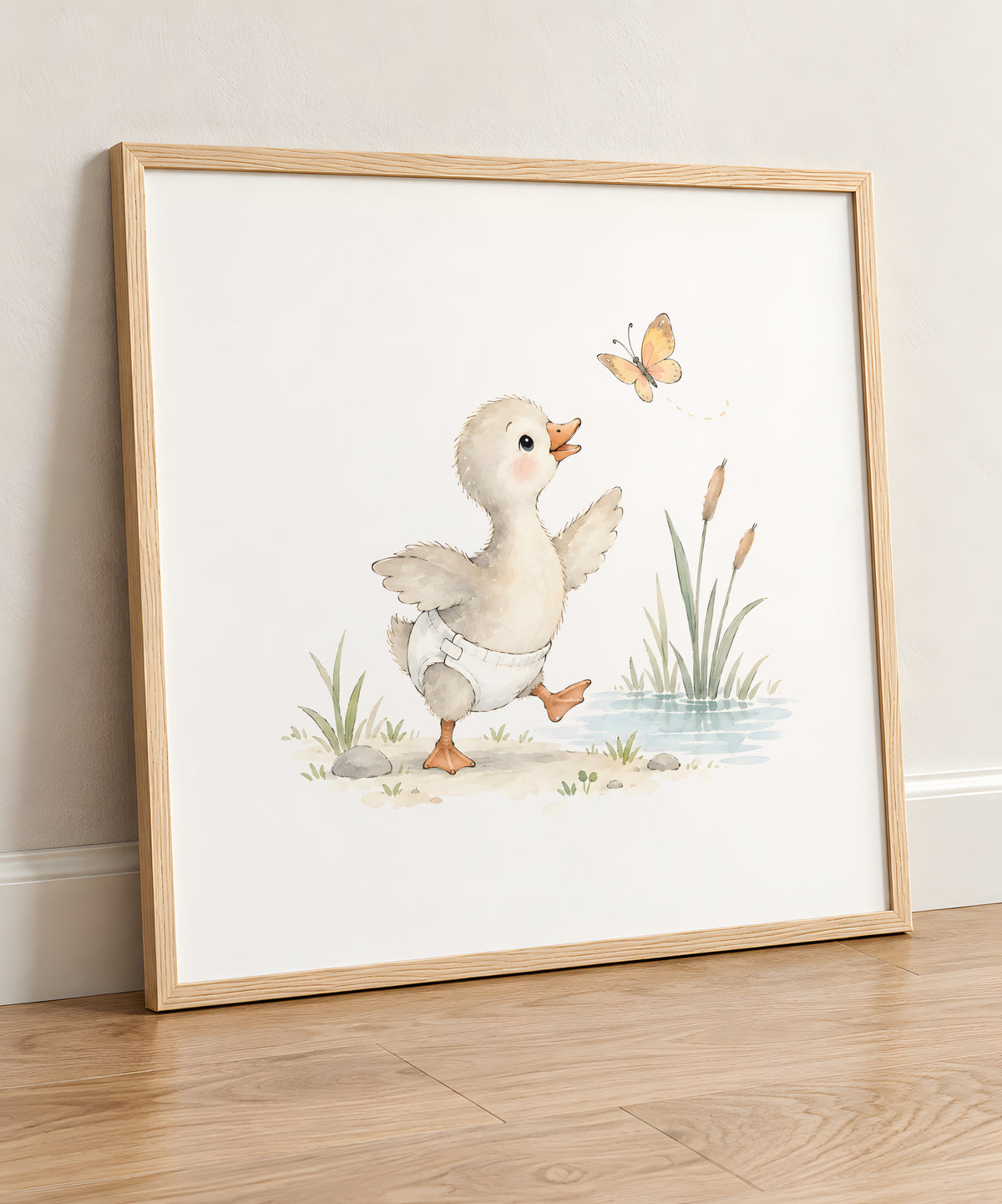 Petit oison en couche blanche tente d’attraper un papillon : cadre bois clair, 50 × 50 cm, en situation
